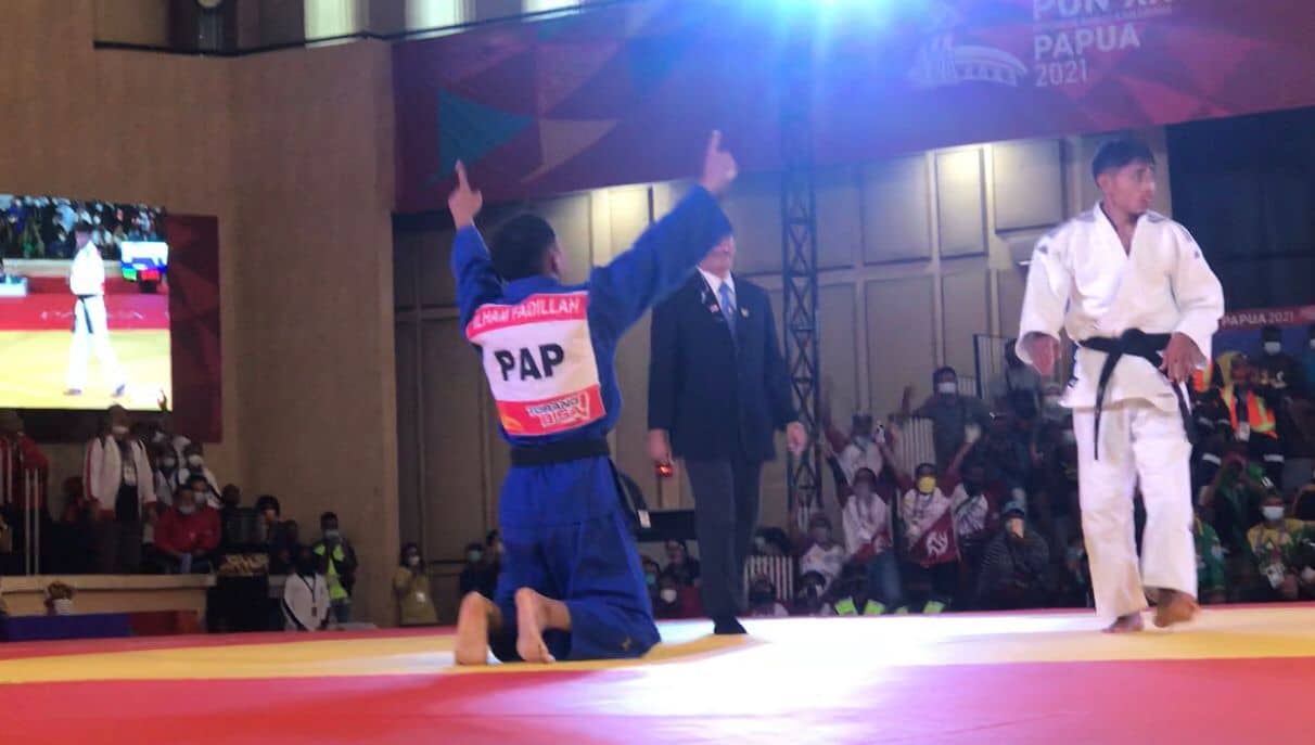 Ilham Fadillah mengangkat kedua tangannya di hadapan Beta Awari setelah diumumkan oleh wasit keluar sebagai pemenang dalam laga final./ Foto : Elfrida Sijabat