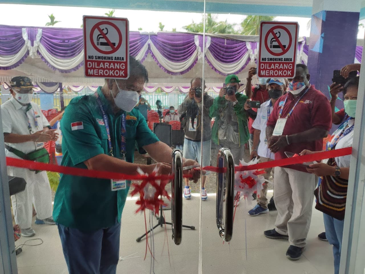 Ketua Harian PB PON XX Papua Sub Mimika Marthen Paiding menggunting pita tanda di bukanya media center Humas PPM PB PON Kluster Mimika(Humas PPM/Ryeno guritno)