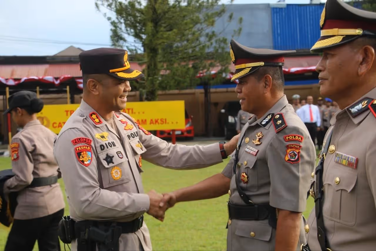 Kapolres Jayapura AKBP Dionisius Helan saat menyematkan tanda jabatan kepada Wakapolres Jayapura Kompol Suheriyono