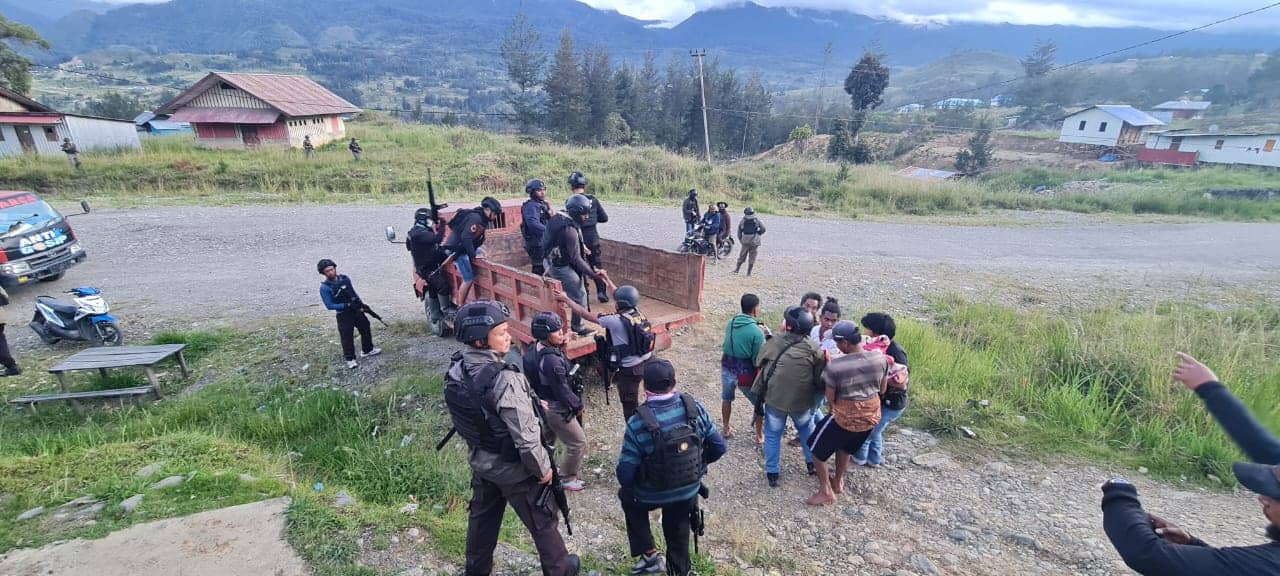 Polisi dan warga mengevakuasi jazad korban menggunakan truk.