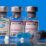Ilustrasi Botol kecil dengan label vaksin penyakit virus korona (COVID-19) Pfizer-BioNTech, AstraZeneca, dan Moderna