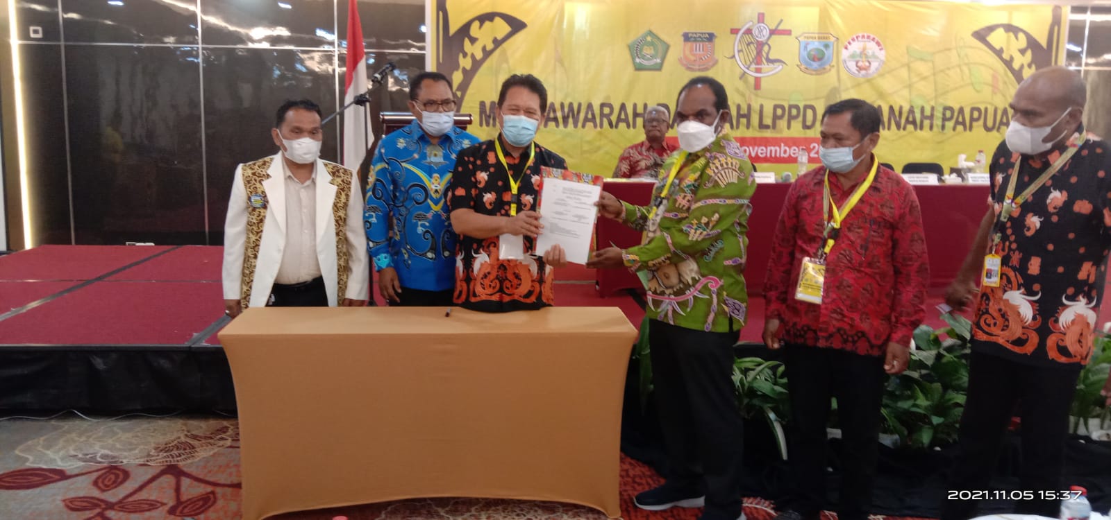Ketua LPPD Papua, Elia Loupaty menyerahkan SK penetapan tuan rumah Pesparawi XIV kepada Bupati Keerom, Piter Gusbager.