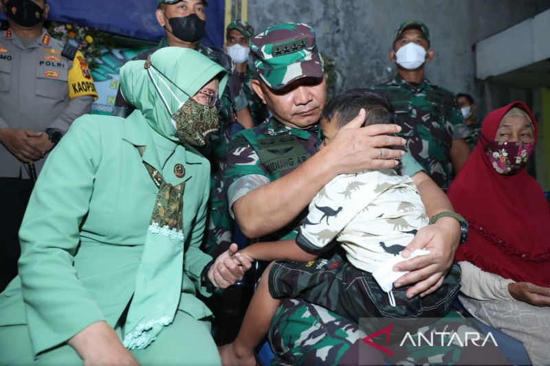 Kepala Staf TNI Angkatan Darat (Kasad) Jenderal TNI Dudung Abdurachman menggendong salah satu putra Sertu Eka saat dia bersama istrinya melayat ke rumah duka, di Sidoarjo, Jawa Timur, Senin (4/4/2022).
